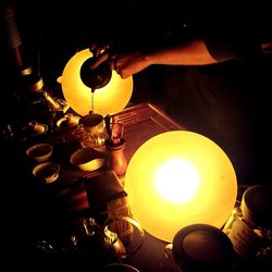 Midsection of person working on illuminated table