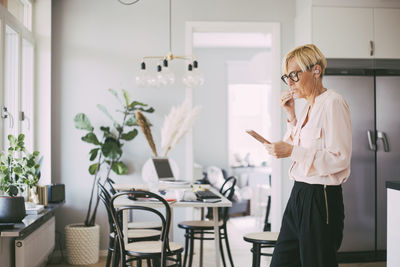 Woman working from home talking on the phone