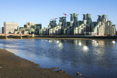 Buildings in city against clear sky