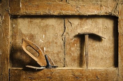Close-up of carpentry tools on dirty wooden niche