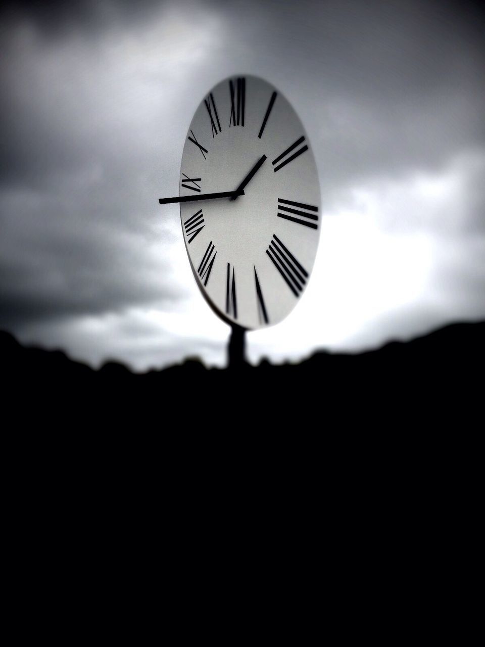 sky, low angle view, time, clock, circle, silhouette, cloud - sky, clock face, no people, cloudy, cloud, outdoors, overcast, nature, dusk, weather, day, geometric shape, sunset, technology