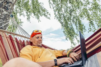 Portrait of man sitting on hammock