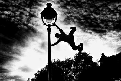 Low angle view of silhouette tree against sky