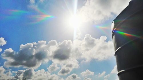 Low angle view of rainbow against sky on sunny day