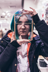 Close-up portrait of woman holding container