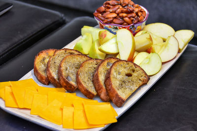 High angle view of apple and bread slices in plate