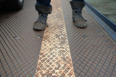 Low section of people standing on tiled floor