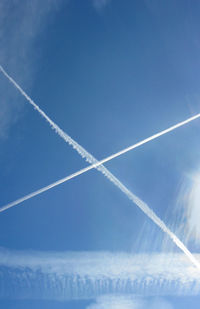 Low angle view of vapor trail in blue sky