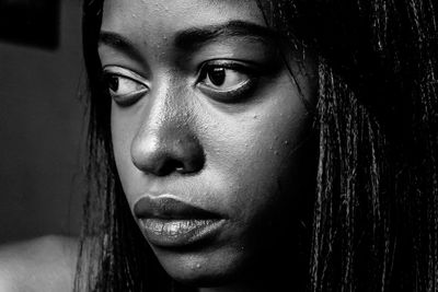 Close-up portrait of young woman looking away