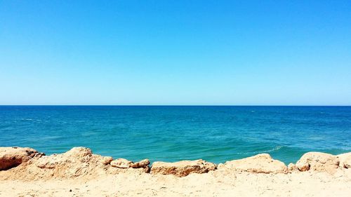 Scenic view of sea against clear blue sky