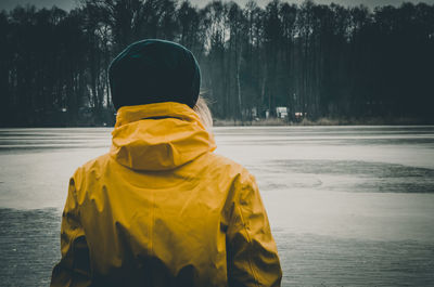 Rear view of person with umbrella in winter
