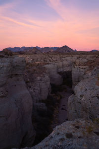 Rock formations against sky during sunset