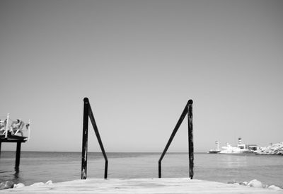 Pier on sea against clear sky