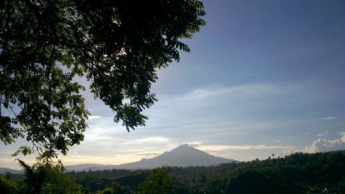 Scenic view of mountains against cloudy sky