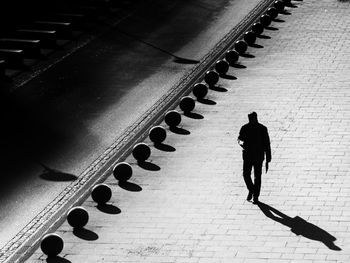 Full length of woman walking on tiled floor