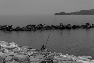 Senior man fishing at sea