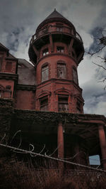 Low angle view of abandoned building against sky