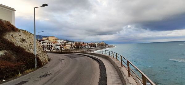 Scenic view of sea by city against sky