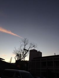 Low angle view of silhouette building against sky