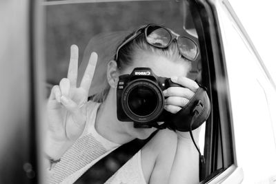 Portrait of woman photographing