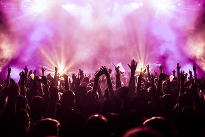 Rear view of silhouette crowd enjoying during music concert