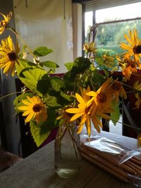 Close-up of yellow flowers in vase on table