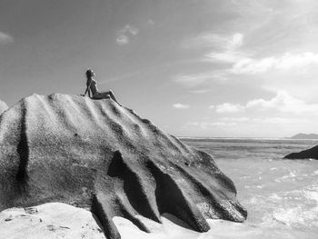 Woman sitting on the big rock