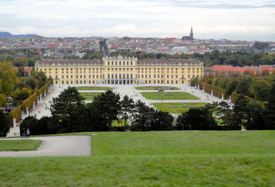 View of trees and buildings against cloudy sky