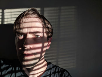 Portrait of young man at home