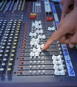 Cropped hand mixing sound in recording studio