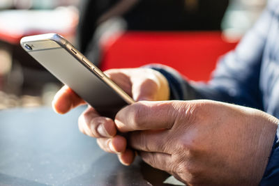 Midsection of man using mobile phone