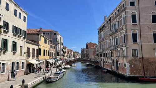 Boats in canal in city