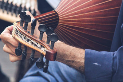 Cropped hands of person playing musical instrument