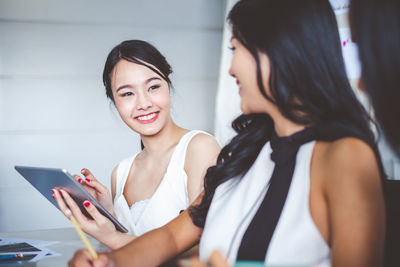 Young woman looking away while using mobile phone