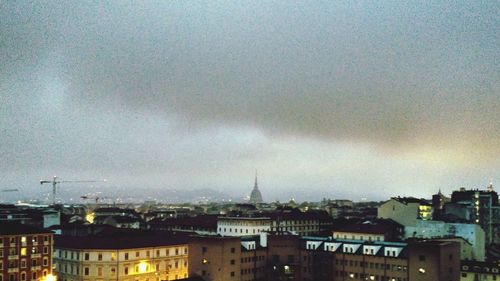 Buildings against cloudy sky