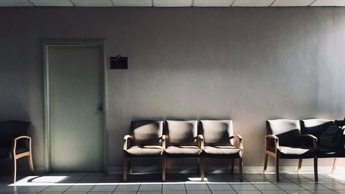 Empty chairs and table against wall at home