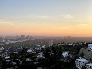 High angle view of buildings against sky during sunset