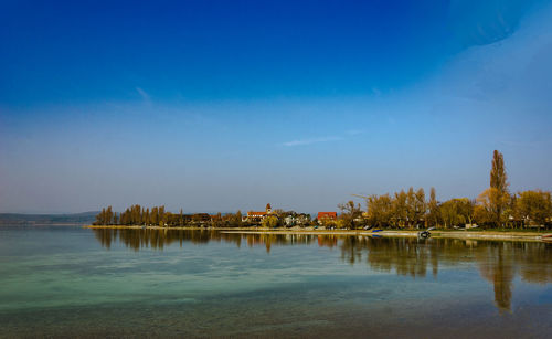 Scenic view of lake against blue sky