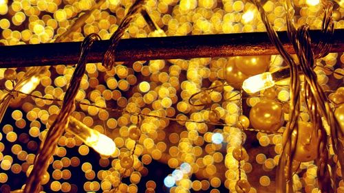 Low angle view of illuminated lights hanging on ceiling