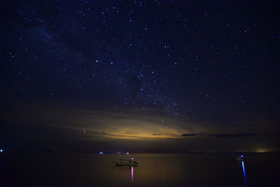 Scenic view of sea against sky at night