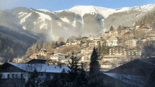 Morning mist in sunny village in valley of austria alps