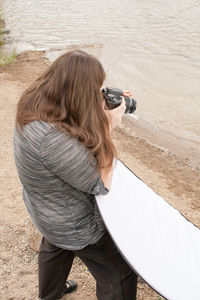 Woman photographing at beach