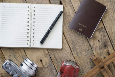 Diary with camera and toy car on table