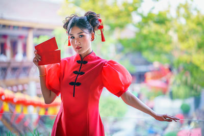 Midsection of woman with red umbrella