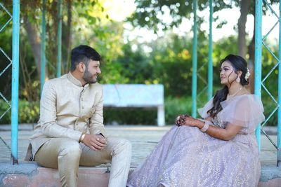 Young couple sitting outdoors