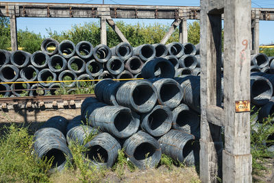 Stack of pipes on field