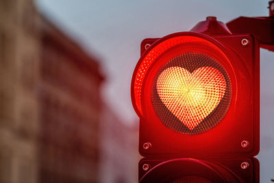 A city crossing with a semaphore, traffic light with red heart-shape in semaphore