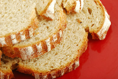 Close-up of bread slices in red plate