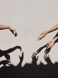 Low angle view of hands playing with shadow