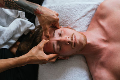 Portrait of shirtless man lying down